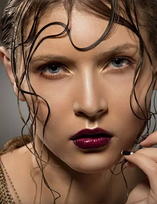 Woman with wet-look fringe on curly hair