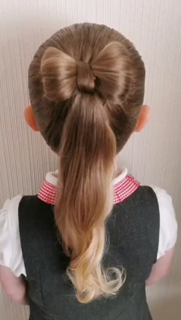 Toddler with a half up bow hairstyle