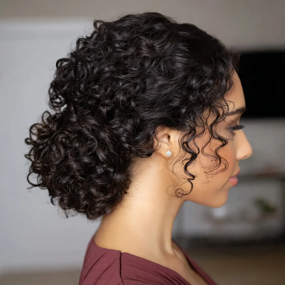 Woman with a low curly chignon