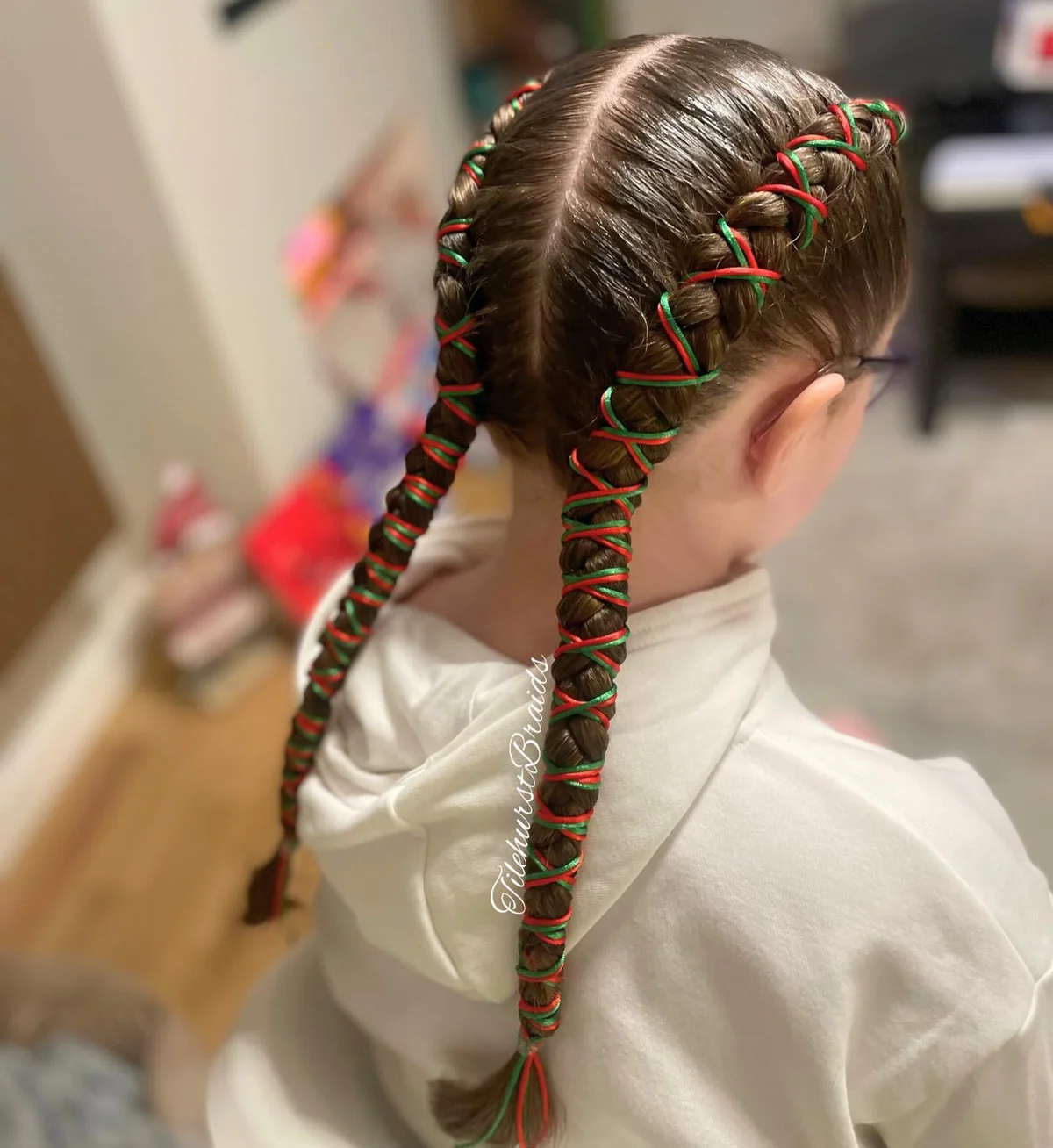 Classic braids wrapped with red and green Christmas ribbon