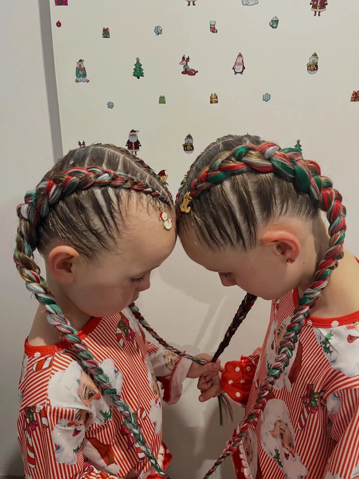 Cornrows flowing into long braids with red, green and white hair