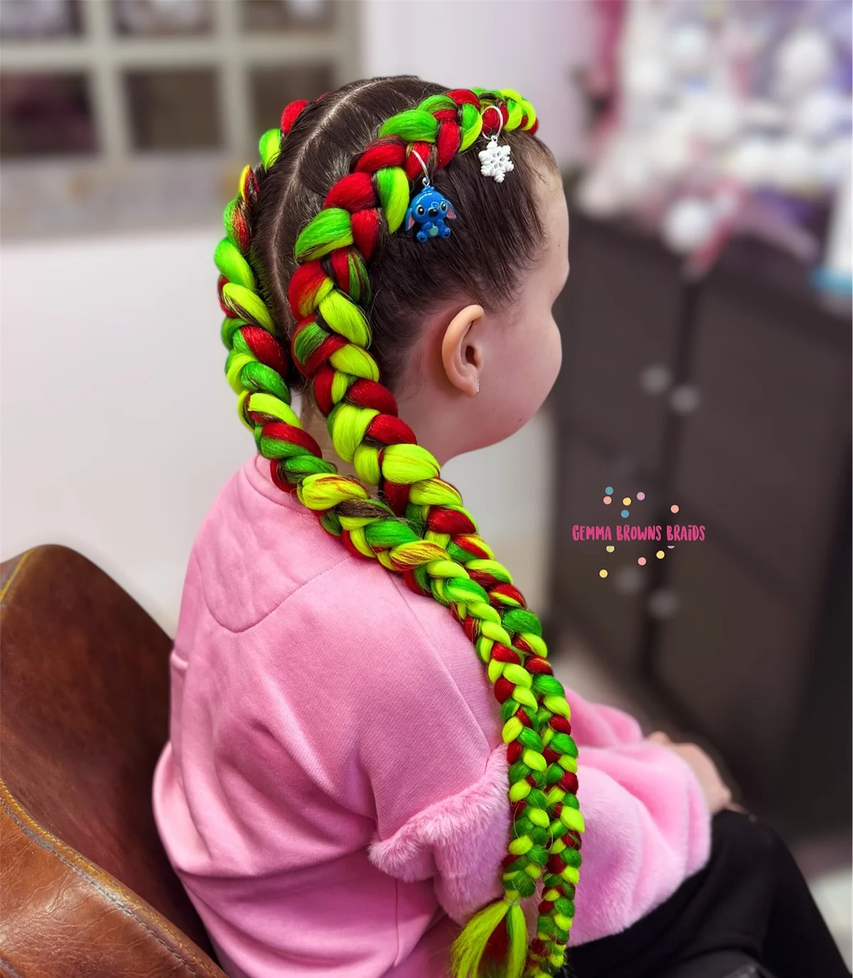 Two thick long Dutch braids worn down the back