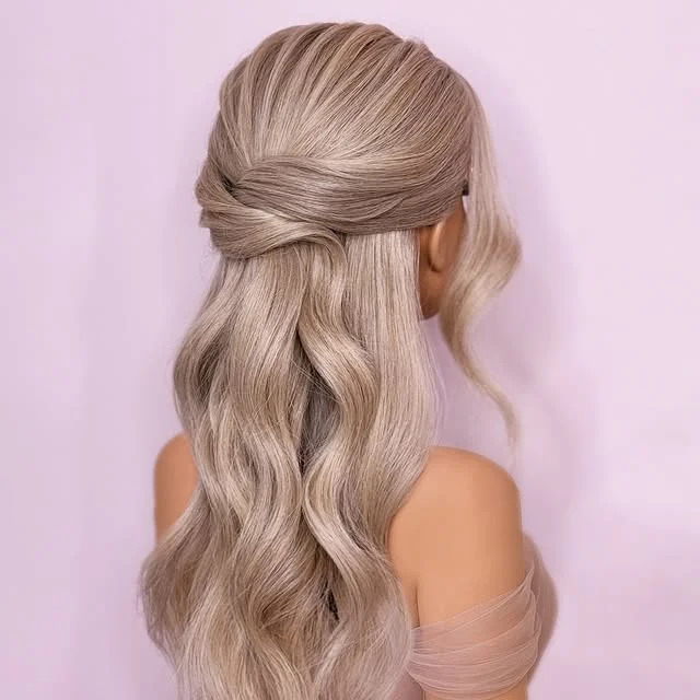 Twisted half-up hairstyle on ash-blonde wavy hair photographed from behind