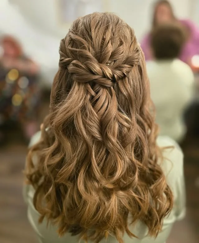 Textured twisted braid across the crown in a half-up wavy style