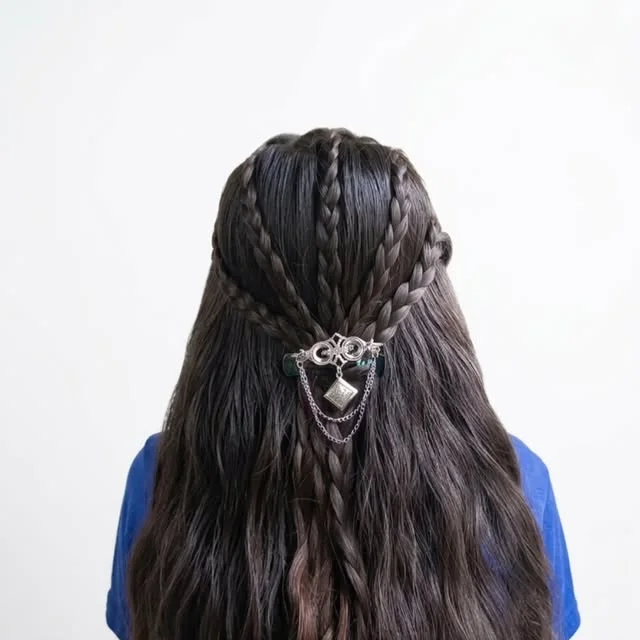 Multiple thin braids gathered at the back with a decorative metal clip
