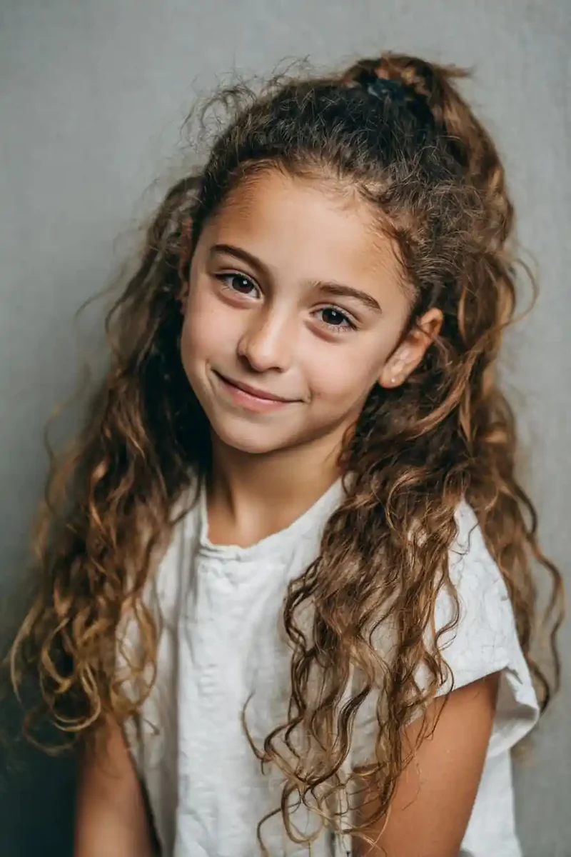 Girl with a low curly puff ponytail
