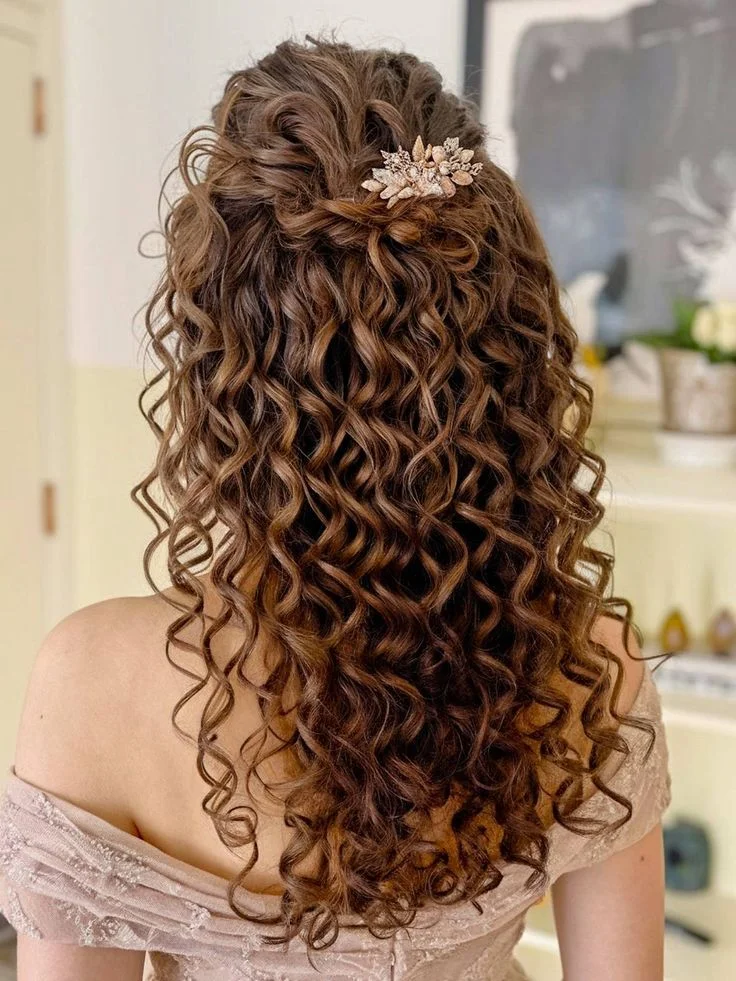 Woman with messy romantic curly half up hair