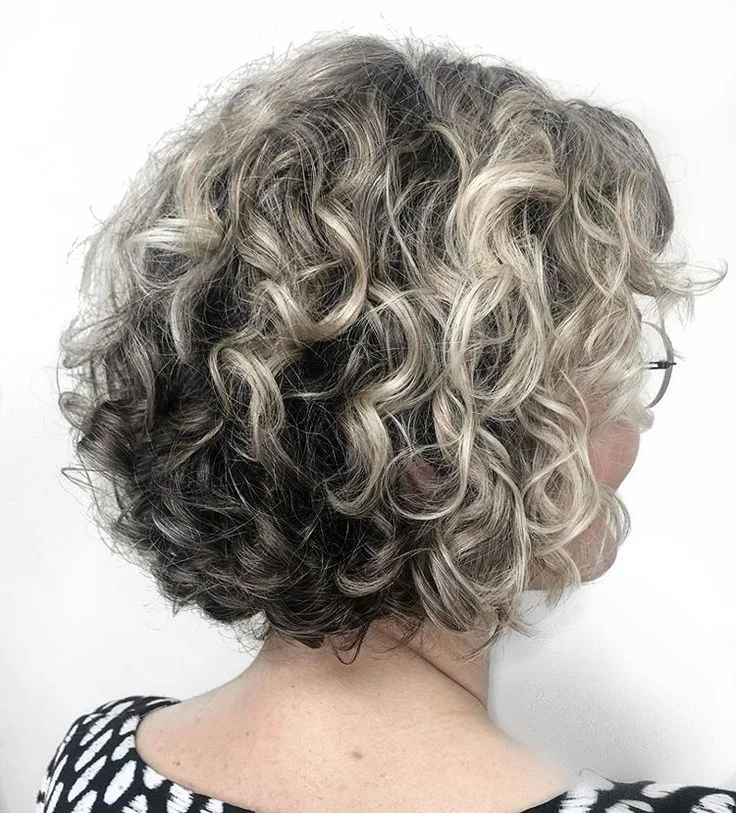 Woman with a layered shoulder length curly bob