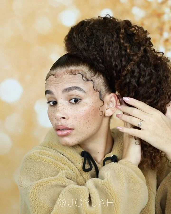 Woman with a glossy curly ponytail