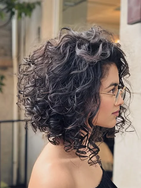 Woman with a classic curly lob haircut