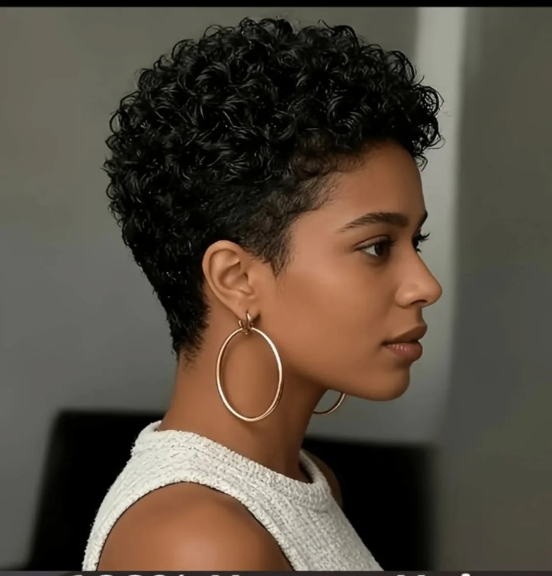 Woman with tapered coil crop curly pixie cut