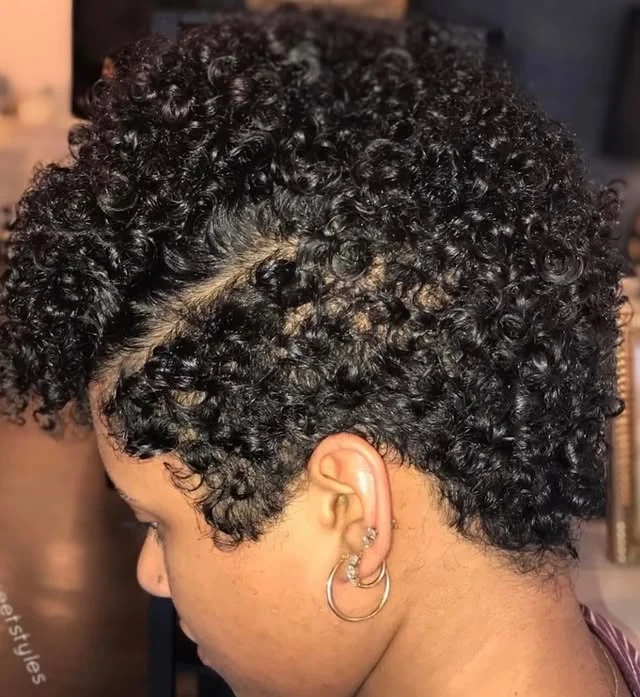 Woman with mini afro taper curly pixie