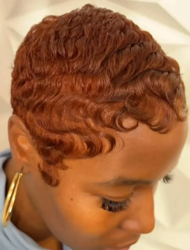 Woman with auburn curly layers pixie cut