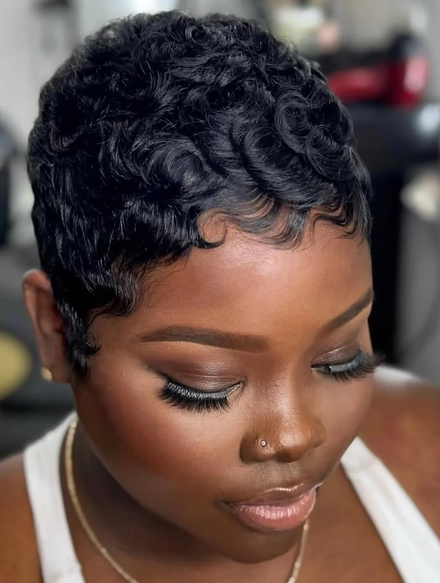 Woman with defined ringlet curly pixie cut