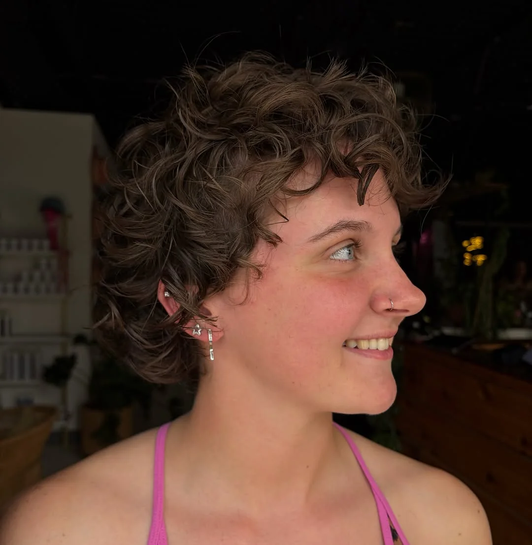 Woman with curly textured shag pixie cut