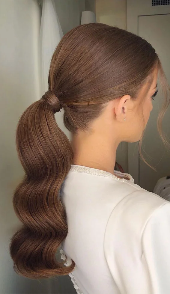 Woman with a textured low ponytail for prom