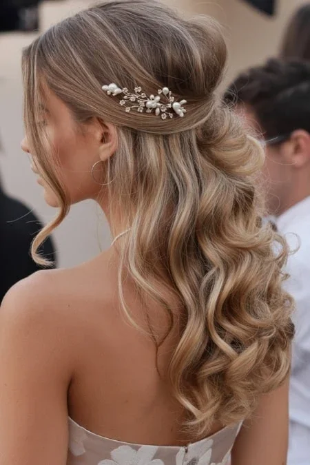 Woman with pearl pins in curly prom hair
