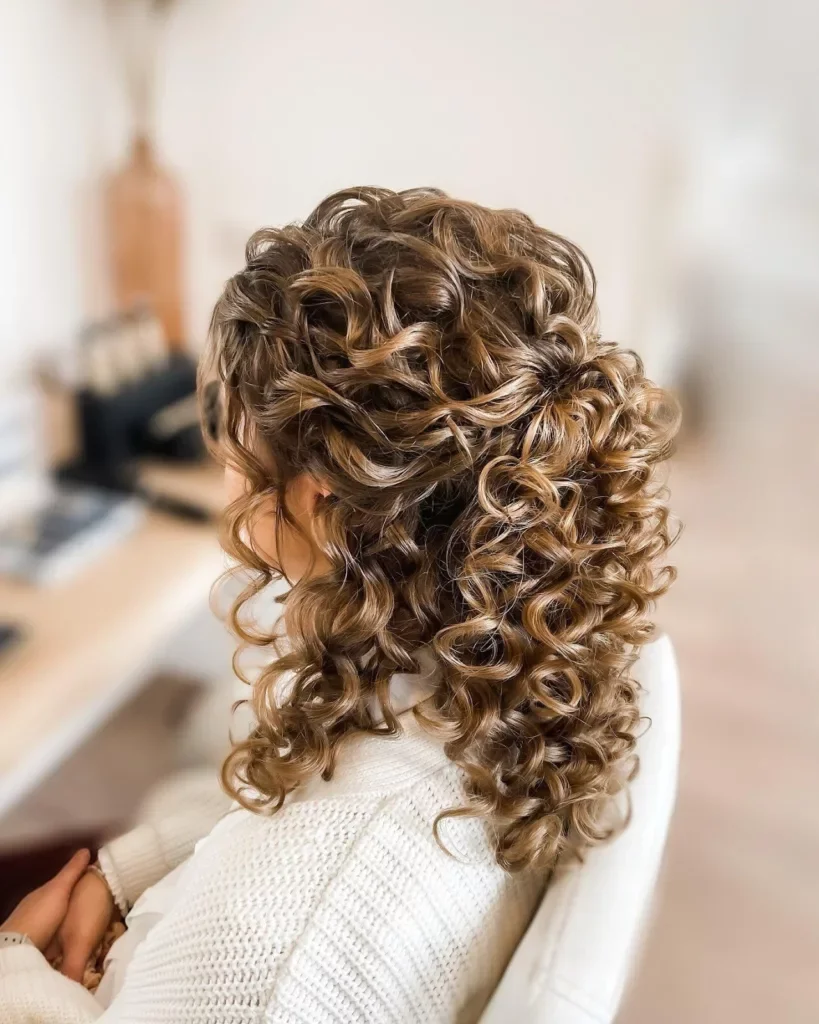 Woman with dramatically pinned sides in curly prom hair
