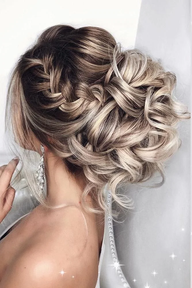 Woman with a low elegant curly chignon for prom
