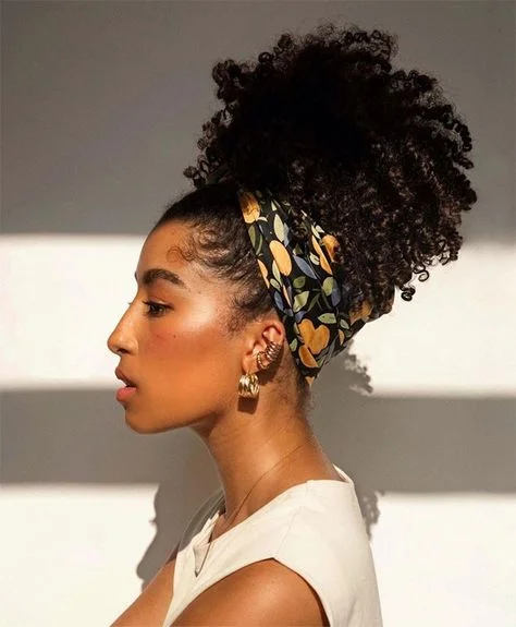 Woman with a scarf wrapped curly updo