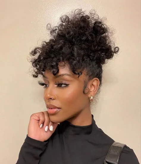 Woman with a messy curly bun updo