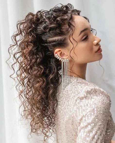 Woman with a high curly ponytail updo