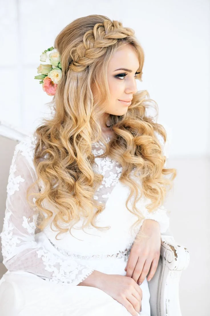 Bride with a loose boho braid in curly hair