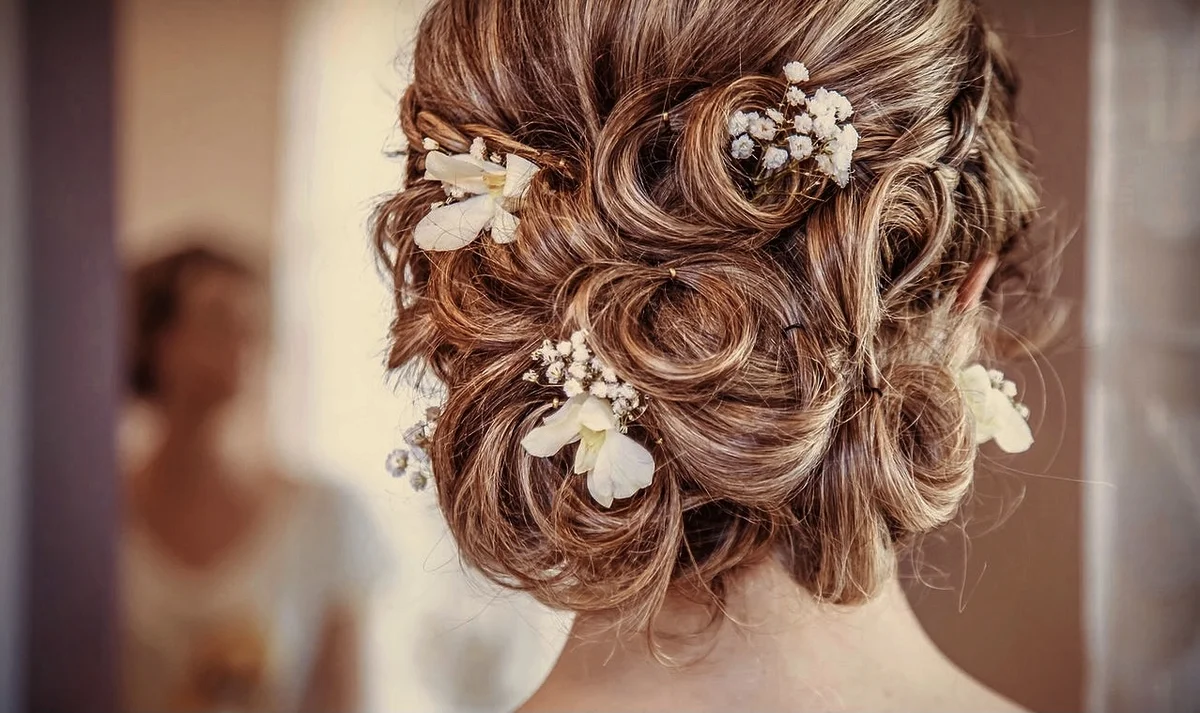 Bride with a floral pinned curly updo