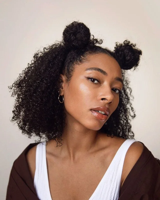 Woman with double space buns in curly hair