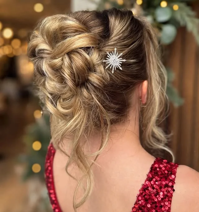 Blonde twisted updo with a sparkling snowflake hairpin, worn with a red sequin dress.