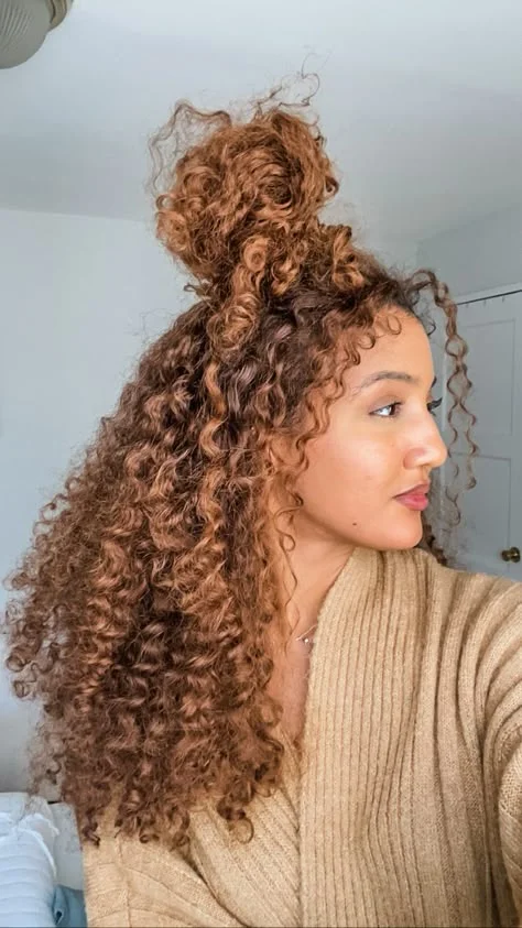 Half up top knot on long curly hair