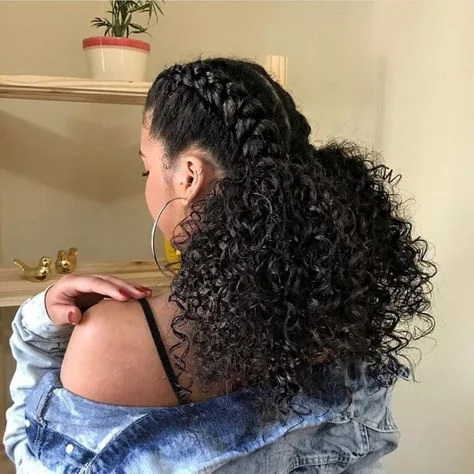 Woman with a twisted halo braid in curly hair