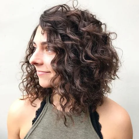 Woman with a textured curly lob haircut