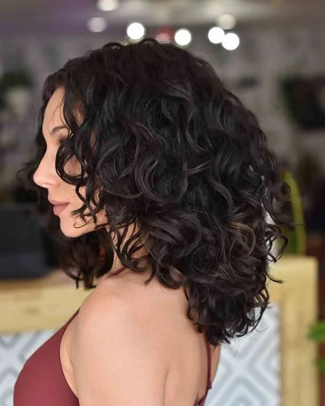 Woman with a bouncy layered curly lob haircut