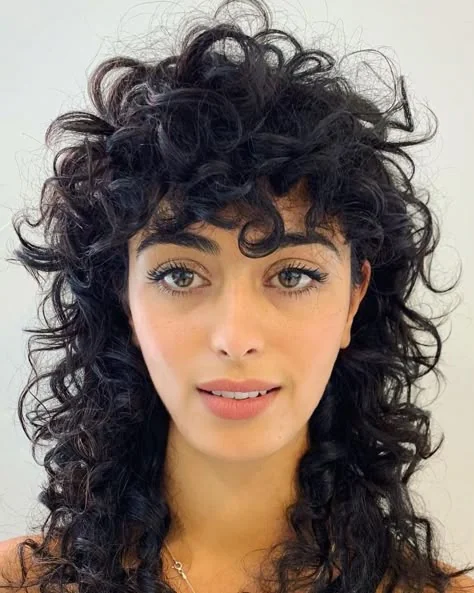 Woman with a curly shag haircut at medium length