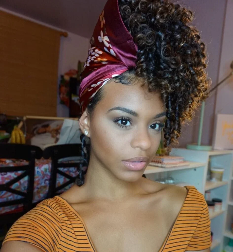 Woman with a curly pineapple puff updo and scarf