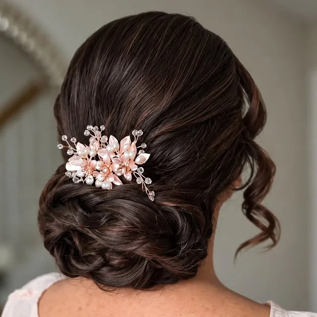 Textured low bun with twisted details and a rose-gold floral hairpiece pinned in.